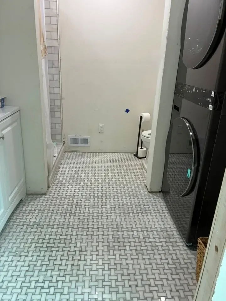 Long laundry and bathroom floor of small white and grey marble basketweave mosaic